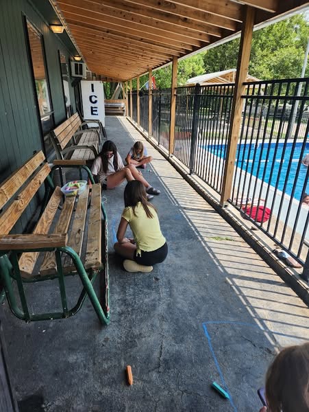 Children enjoying crafts beside the campground pool